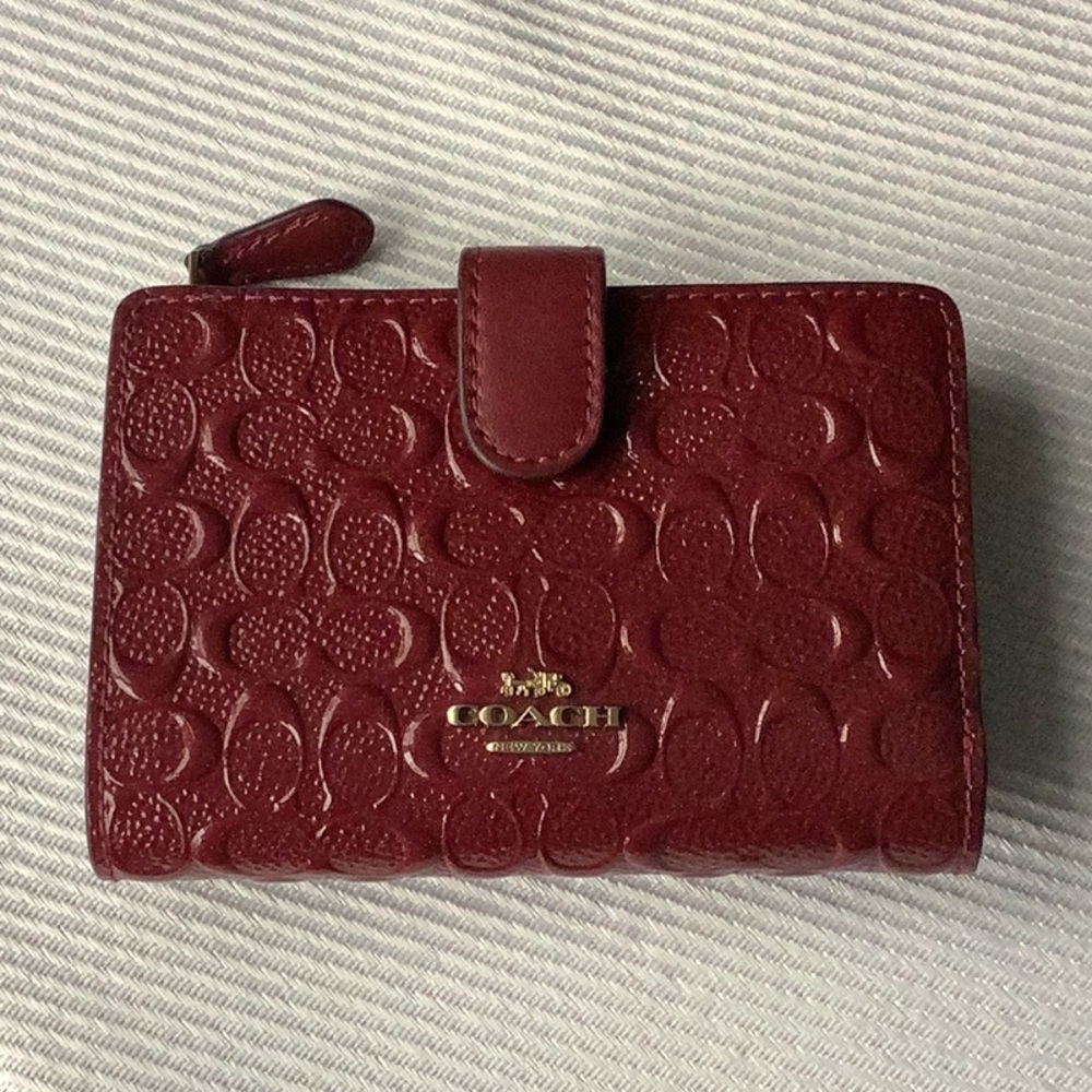 Coach lady’s patent leather wallet. Color -Magenta